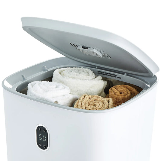 White sterilizer with towels and cloths inside on a white background