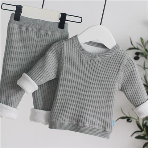 Gray ribbed sweater and shorts set on hangers against a white background