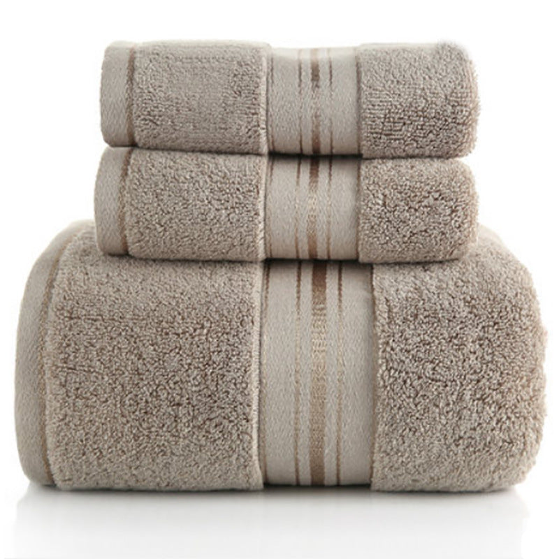 Stack of beige towels with striped pattern on a white background