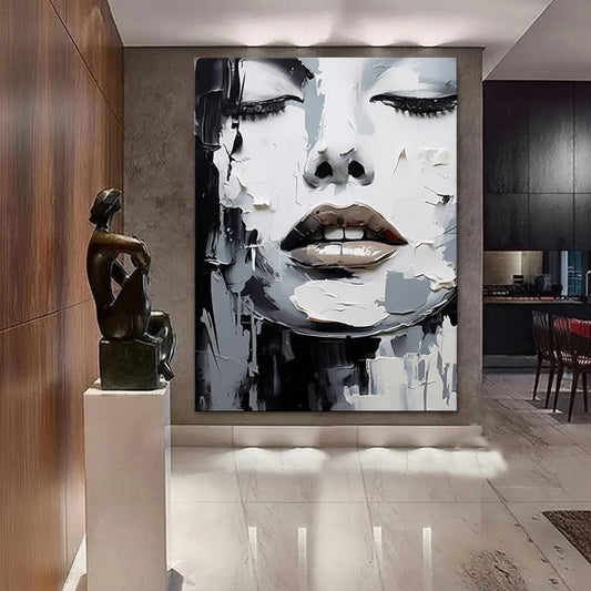Modern interior with abstract wall art of a face and a bronze sculpture.