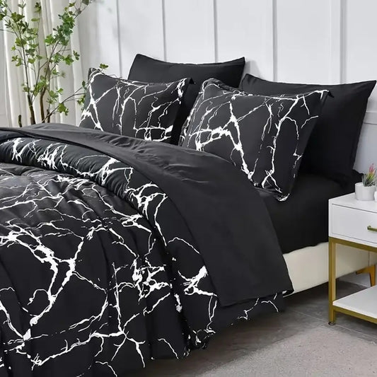 Black and white marble patterned bedding set on a bed in a bedroom.