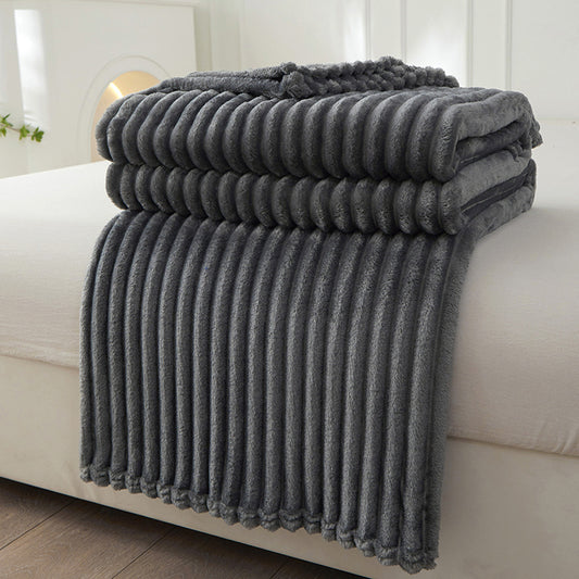 Folded gray blanket on a white couch