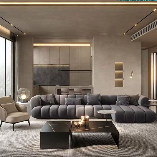 Modern living room with a gray sectional sofa, coffee table, and armchair.