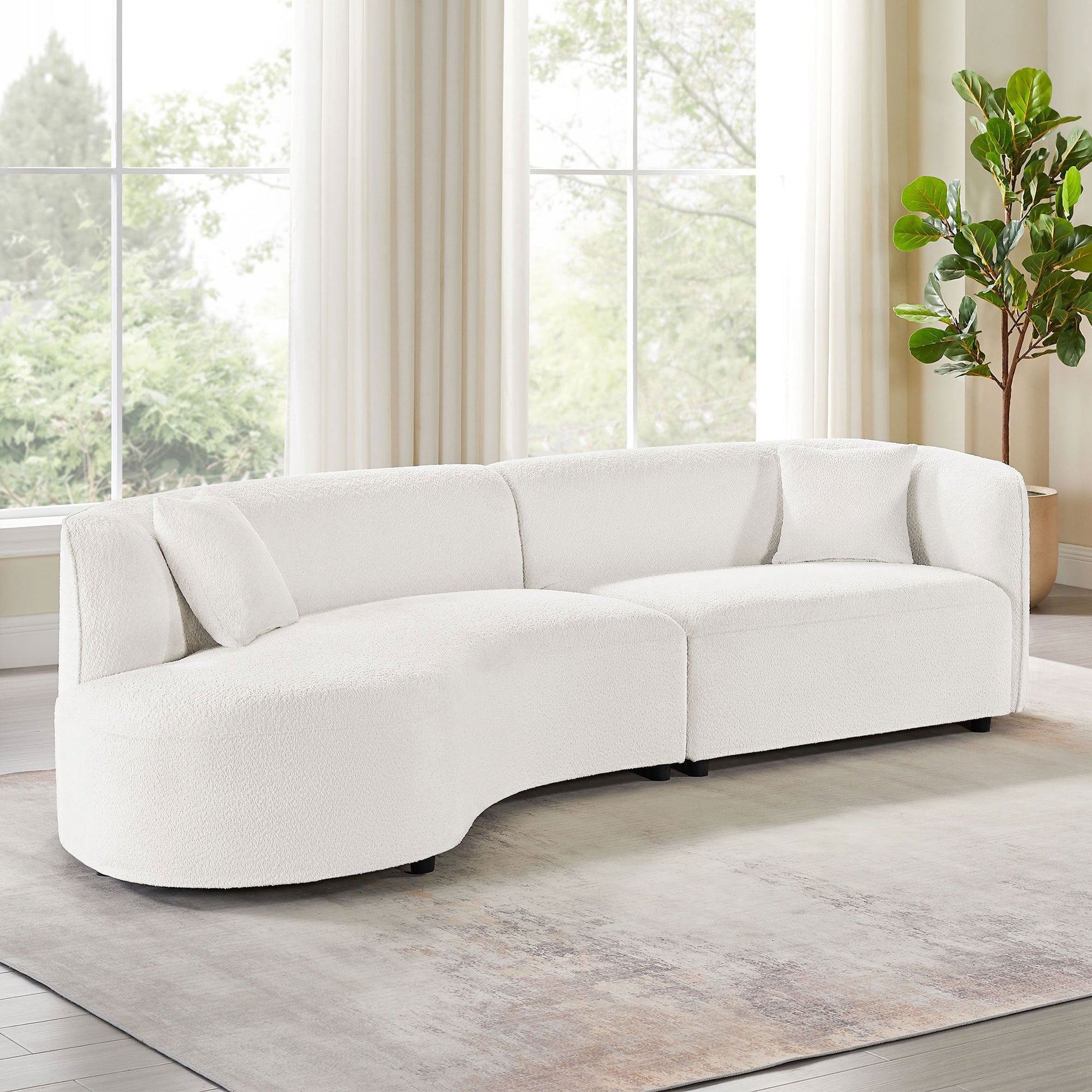 Curved upholstered sofa with chaise lounge in luxury modern design, plush cushioning and elegant curved silhouette for contemporary living room comfort