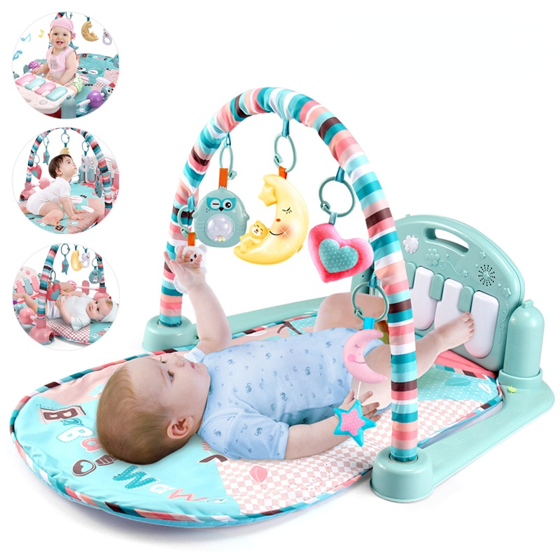 Baby playing on a colorful activity gym with various hanging toys.