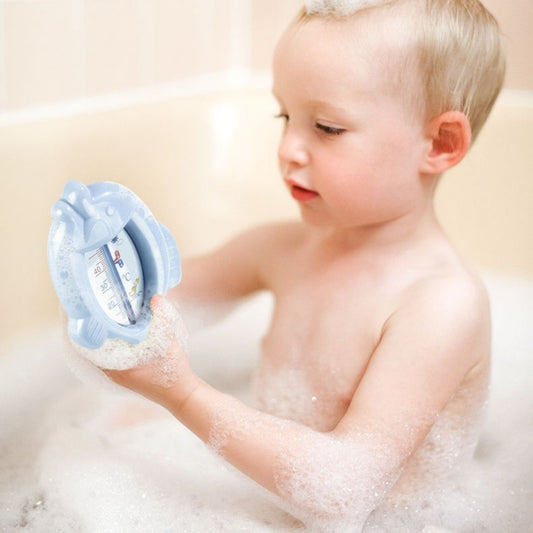 Child in a bathtub with a water temperature monitor